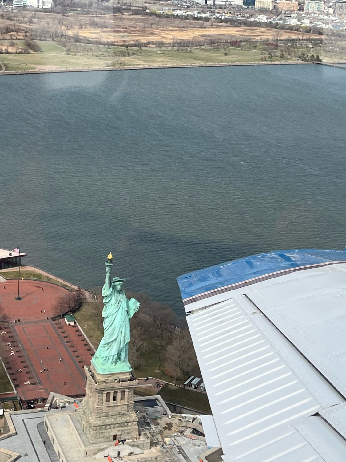 The Saratoga's wingtip over the Statue of Liberty